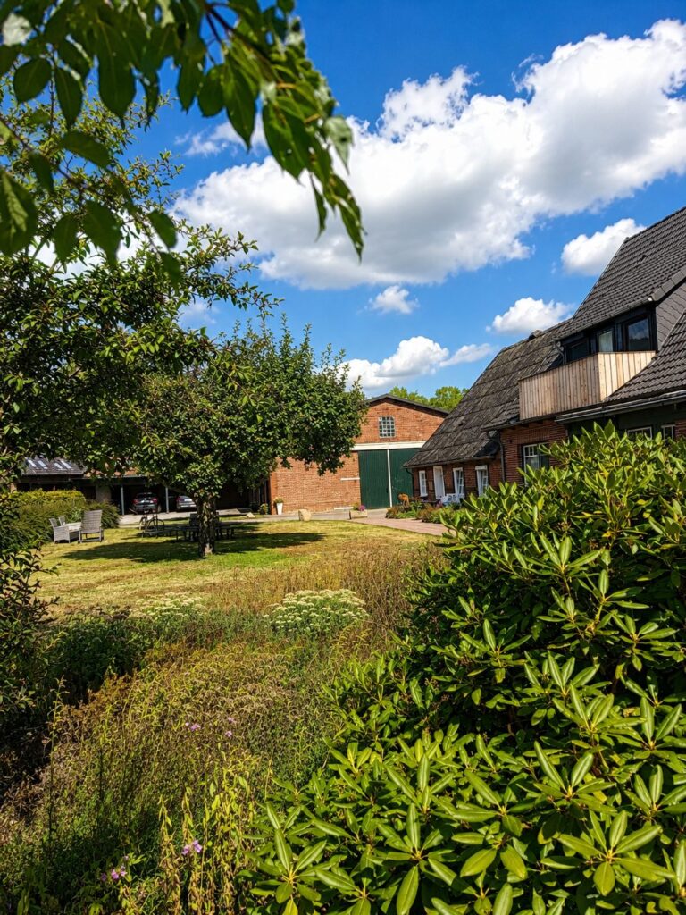 Der Resthof mit Garten unter blauem Himmel